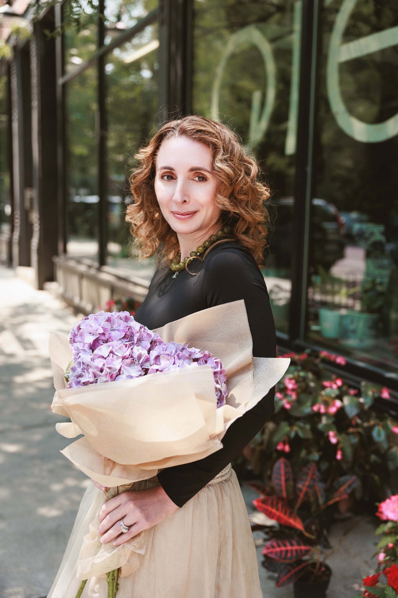 Lauren Fine holding a bouquet of hydrangeas