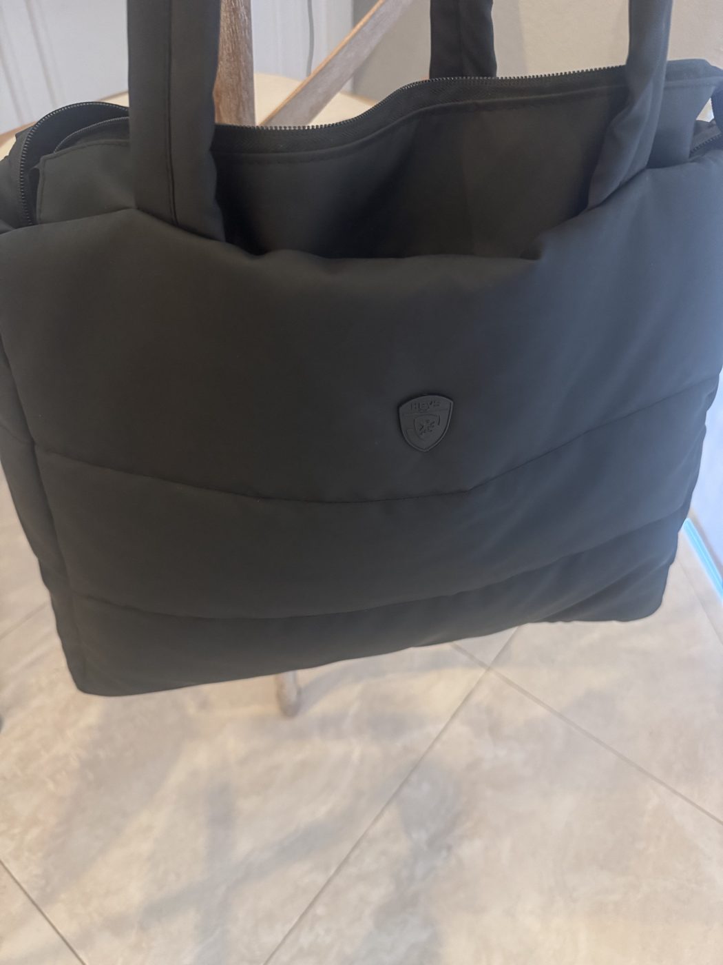 Lauren's black Heys Puffer Travel Tote